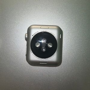 Apple Watch Series 1 38mm with cream beige band and speed charger.